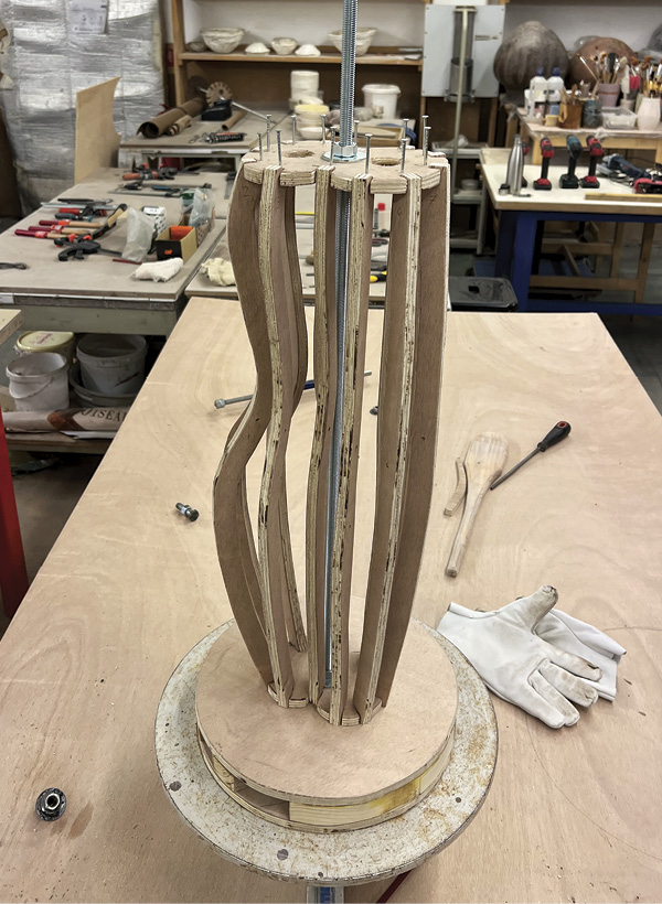 4 Attach the wooden ribs and the base assembly to a pottery wheel.