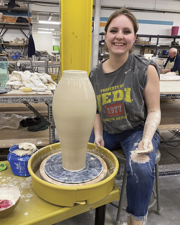 Holly Barrett Truong stacking a large vessel, 2024. Photos: Jon Stein. Queen City Clay, Norwood, Ohio.