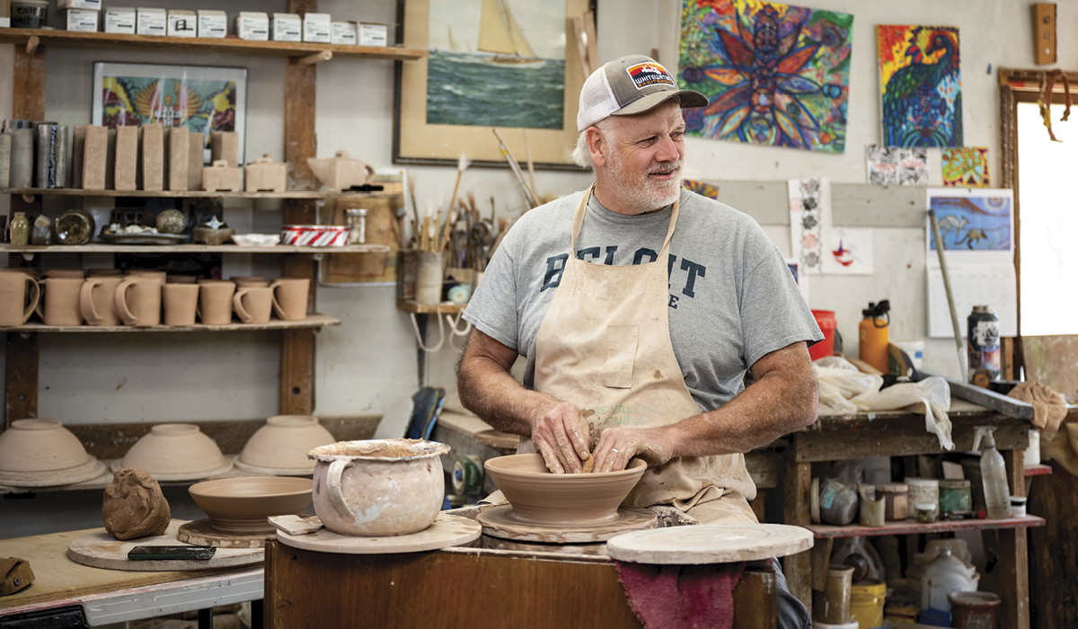 1 Sam Taylor throwing a bowl on his handbuilt treadle wheel.