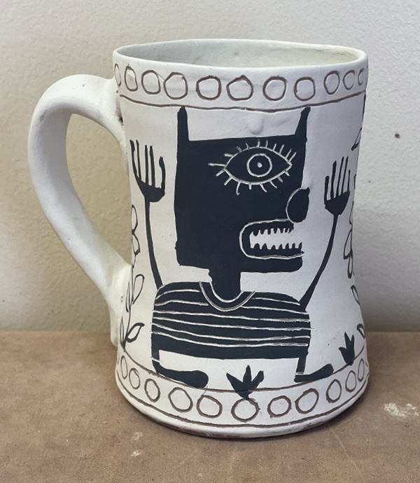 11 Carve through underglaze to add character details.