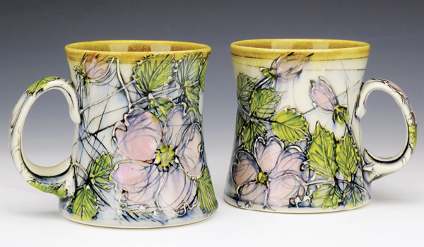 Dawn Candy’s Wild Rose Mugs, 6 in. (15 cm) in width, wheel-thrown porcelain, trailed and inlaid slip, stains, underglazes, including Amber Liner Glaze on the interior and rim, fired to cone 6 in an electric kiln, 2018.