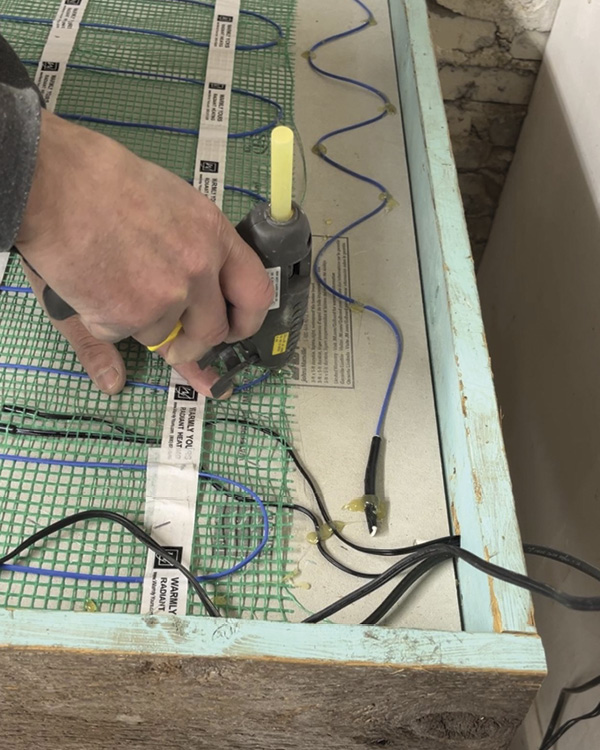 1 Installing the Warmly Yours heating unit into the prepared table frame.