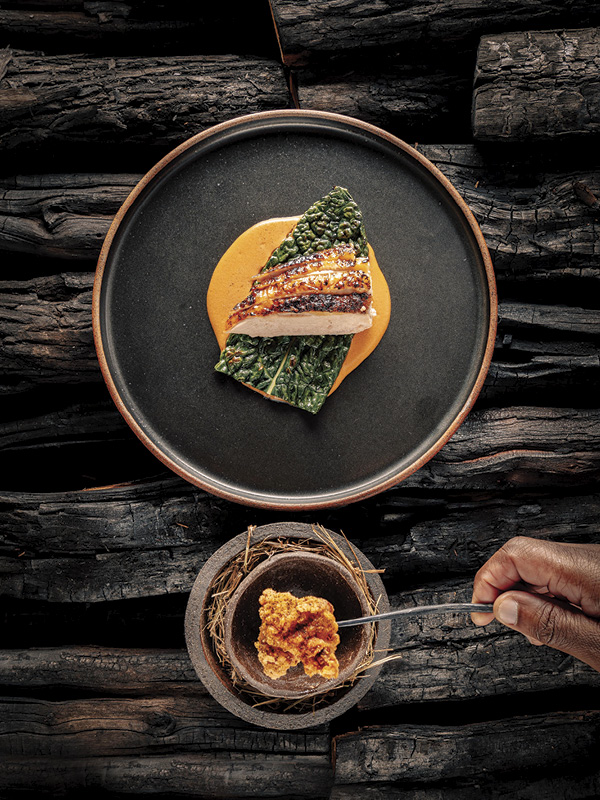 3 Jun Rhee's Plate, red-brown stoneware, black semi-matte glaze, fired in reduction to cone 10 in a gas kiln. In use at Akoko, a one Michelin star restaurant in London, UK. Photo: Akoko.