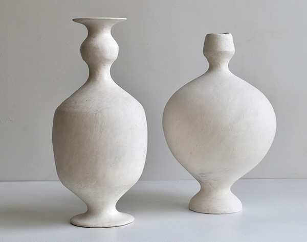 4 Maggie Jaszczak’s white vases, 13 in. (33 cm) in height, wheel-thrown and handbuilt earthenware, brushed 04 White Slip, Matte Base Glaze, fired to cone 04 in an electric kiln.