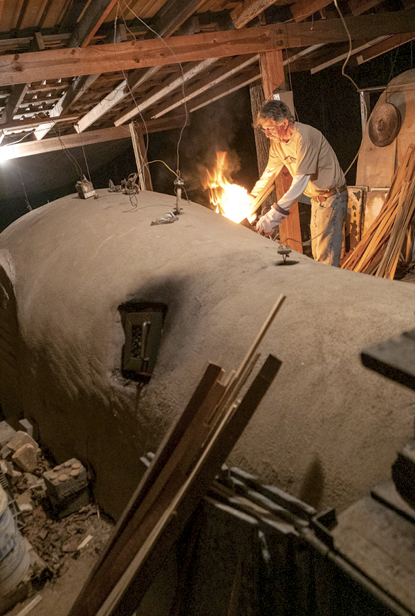 3 Roger Jamison side stoking his anagama kiln in Juliette, Georgia. Photo: Joel Huff.