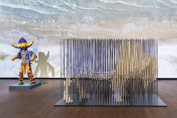 1 Cannupa Hanska Luger’s Census (foreground), 6 ft. 8 in. (2 m) in height, approximately 20,000 ceramic beads, steel, 2025.