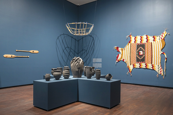 2 Cannupa Hanska Luger’s Irabágu (foreground, installation view), various dimensions, thirteen ceramic vessels, 2025.