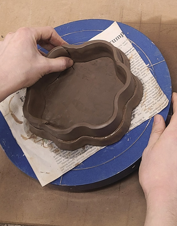 7 Use a wooden pony roller to soften the edges of each strip before pinching the slab around the base of the basket.