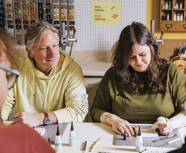 1 Workshop attendees share materials and conversation across the table at Pewabic Pottery.