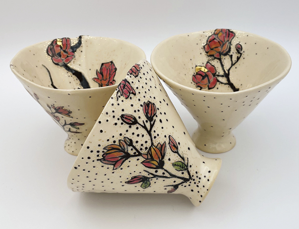1 Ishara Sweeney’s Magnolia Sippers, 4½ in. (11 cm) in width, handbuilt porcelain, underglaze, water etched, glaze, fired to cone 6 in oxidation, 22k gold luster, 2023.