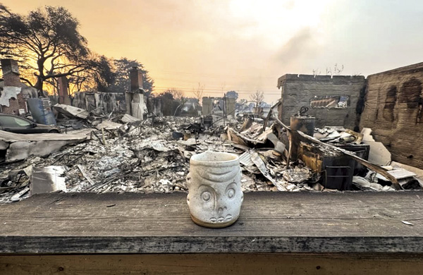 2 Ash covered ceramic mug was altered by the intense heat.