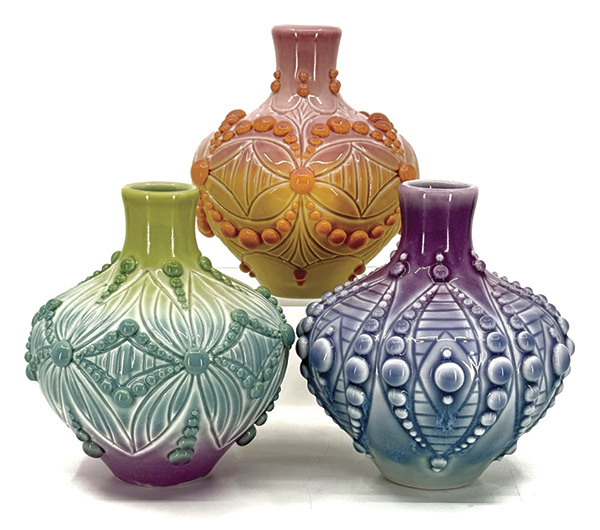 2 Ali Schorman's Bud vases, 4½ in. (11.4 cm) in width (each), slip-cast, hand-carved, and slip-trailed porcelain, fired to cone 6, 2025.