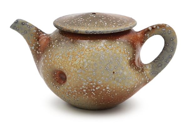 1 Jason Wang's Titanium Yellow Orange Teapot, 8 in. (20.3 cm) in width, white stoneware, glaze, fired to cone 10 in a soda kiln, 2025.