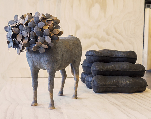 2 (Left to right) Mathew McConnell’s Many Things New and More of the Same, 17 in. (43.1 cm) in length, raku-fired red earthenware, 2010; What it Means to Move, 14 in. (35.5 cm) in length, earthenware, bone charcoal, graphite, 2013.