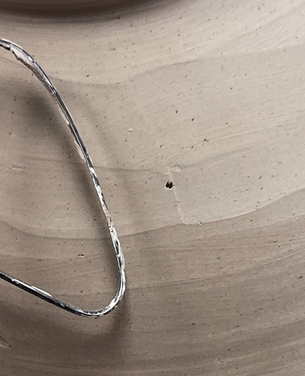 3 When the trimming tool contacts the head of the tack, you’ll feel and hear a subtle tick—signaling that the target thickness has been reached.