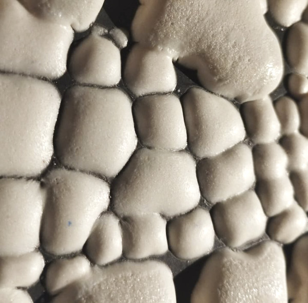 2 Close-up detail of the crawling glaze surface demonstrating variations in crawling patterns depending on glaze thickness.