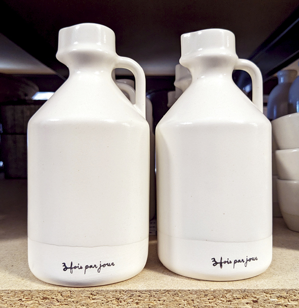 11 A pair of maple-syrup jugs branded for “Trois Fois Par Jour,” a popular Quebec food blog and retailer, and one of Atelier Tréma’s partners.