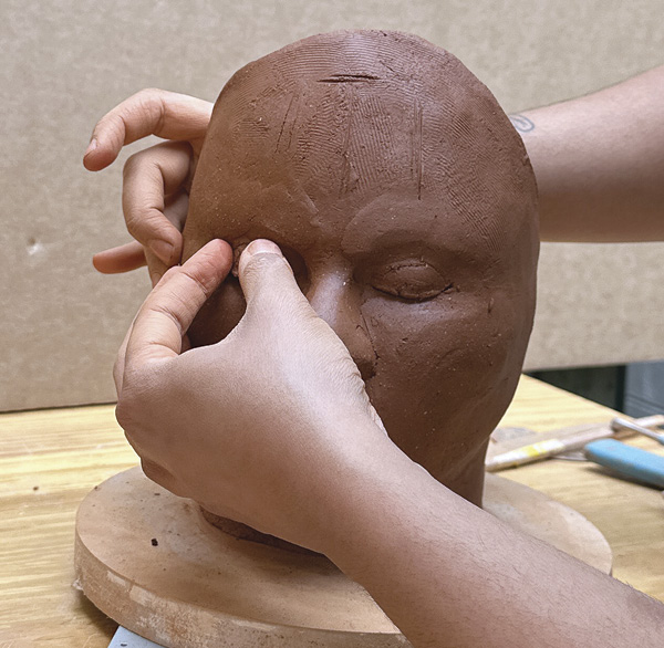 14 Utilize the additive method to refine the facial volumes, and use a damp paintbrush to smooth the detailed surfaces.