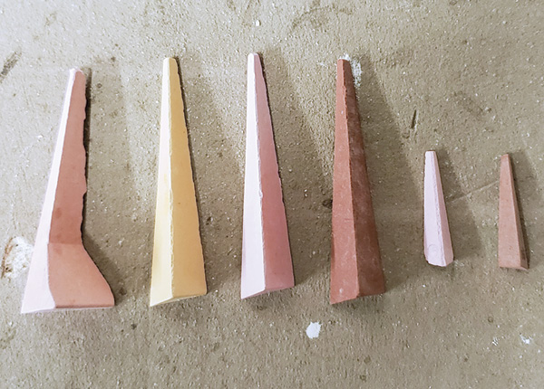 1 Different types of pyrometric cones, left to right: one self-supporting cone, three large cones, and two small sitter cones.