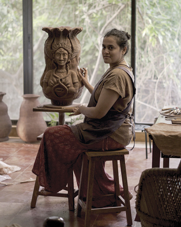 3 Jain carving in her bedroom turned studio during the pandemic, Mumbai, 2021. Photo: Anant Jain.