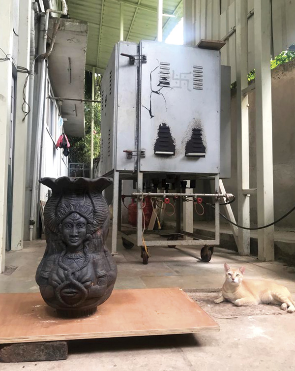 7 Ma Manasa, just out of the gas kiln in the backyard of the home studio, with cat, Tara, 2022.