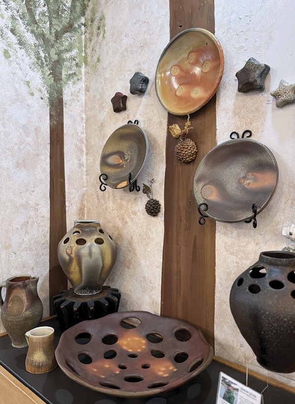 2 Display of wood- and soda-fired ceramics by Simon Levin (front), Isaac Howard (wall), Jesse Jones (wall), Jennifer Nerad (wall), and AnnMarie Cooper (wall), 2025. Photo: AnnMarie Cooper.