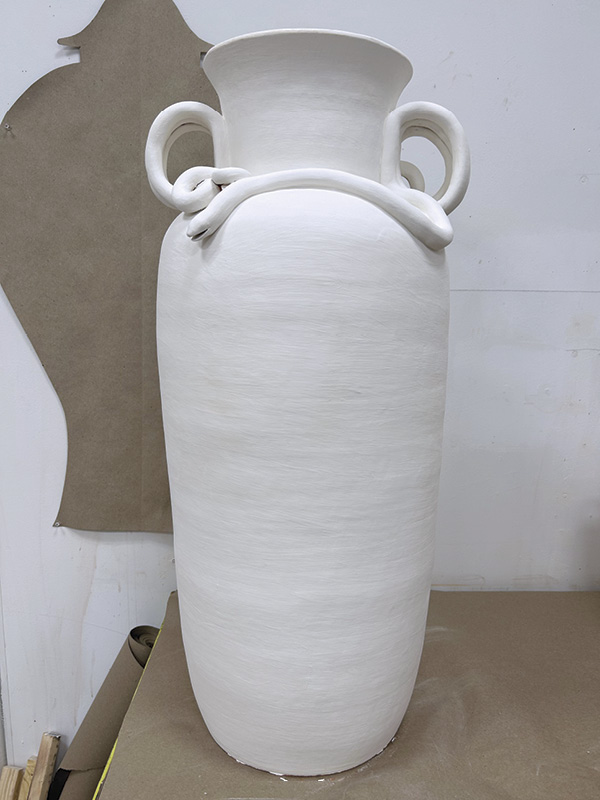 1 Bisque fire a terra-cotta vessel with white slip to cone 04.