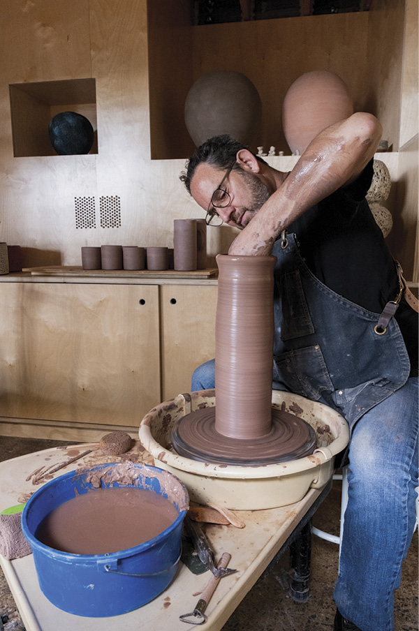 3 Owner and Founder of Tao of Clay, Josh Herman, working in his studio within Tao of Clay.