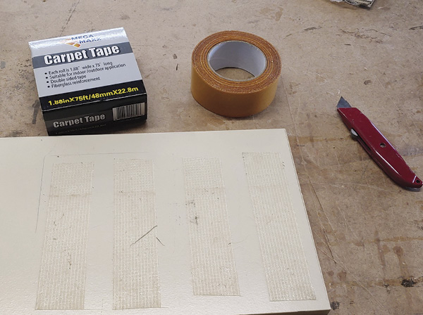 5 Apply carpet tape to wood and press linoleum firmly into place, making sure it is square to the wood.