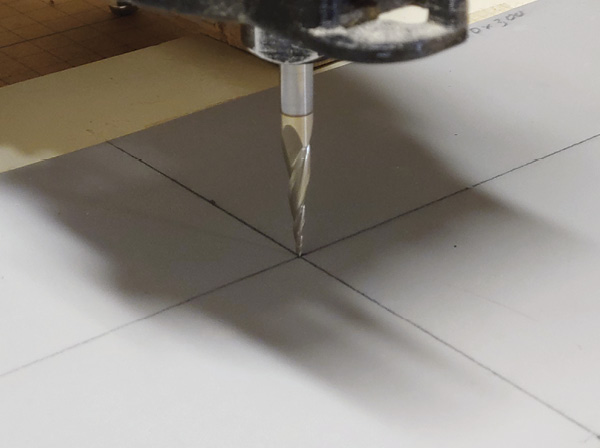 8 Align the tip of the bit to the center of the linoleum.