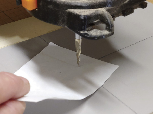9 Move the bit up and down until a piece of paper barely slides out from under it.
