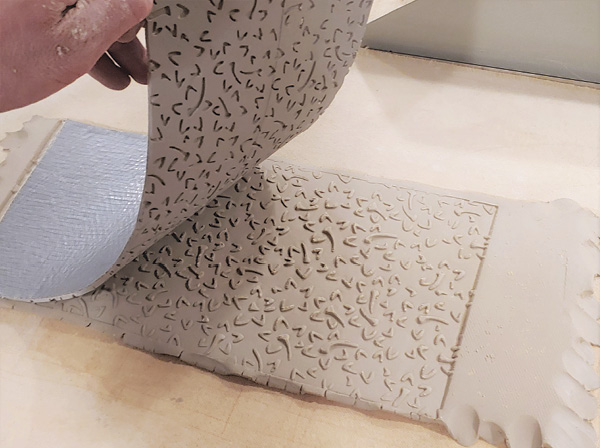 12 Position mat on top of slab of clay. Use a rolling pin or slab roller to impress the pattern and then peel the texture mat from the clay.