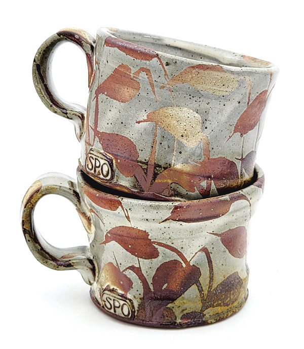 3 Sean O’Connell's Mugs, 3½ in. (8.9 cm) in height (each), wheel-thrown stoneware, slip, glaze, hand-painted wax resist, fired in reduction to cone 10 in a wood kiln, 2025.