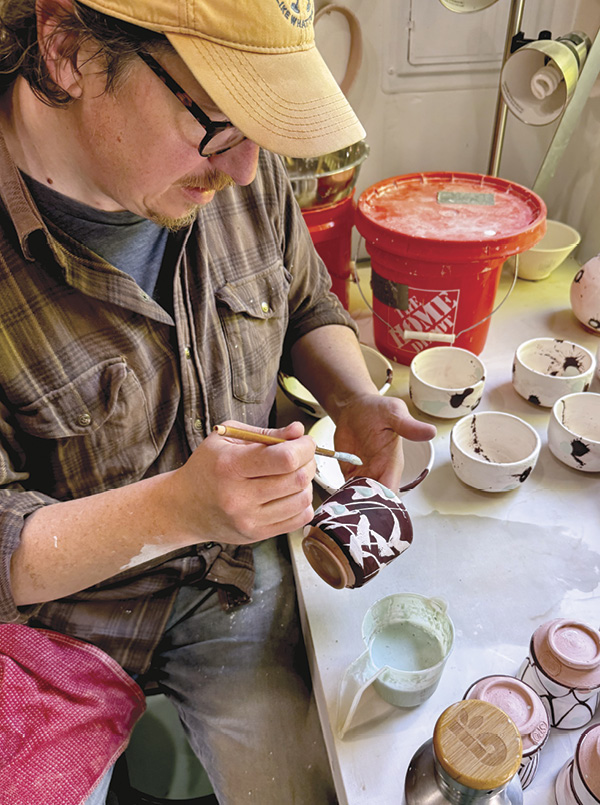 4 O’Connell adding glaze decoration to mug. Photo: Julie Wiggins.