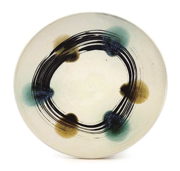 11 Sean O’Connell's Dinner plate, 10 in. (25.4 cm) in diameter, wheel-thrown stoneware, slip, glaze, hand-painted black underglaze, fired in reduction to cone 10 in a wood kiln, 2022.