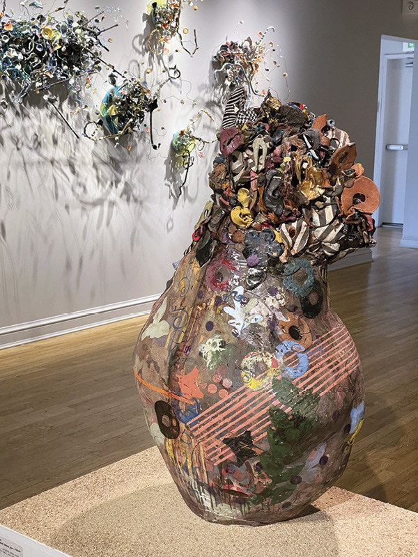 5 Foreground: Adero Willard’s BlokashGi (flesh, blood, bone) Prunck, 3 ft. 5 in. (1.1 m) in height, slab- and coil-built red clay, slip, underglaze, glaze, luster, Egyptian paste, multiple firings, 2023; background: Io Palmer’s Meander, 8 ft. 2 in. (2.5 m) in width, mid-range clay, slips, underglazes, wire, metal brace, wood, jewelry wire, laser-cut Plexiglas, 2025.