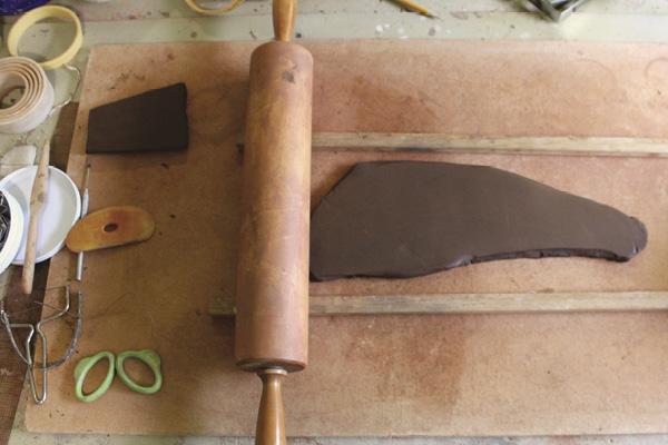 1 Roll out a slab of groggy stoneware using ½-in. (1.3-cm)-thick wooden thickness strips and a rolling pin.