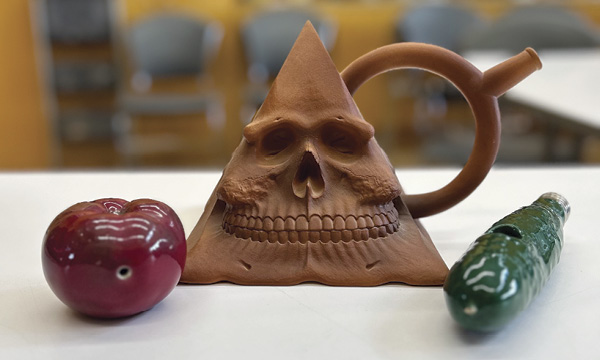 3 Richard Notkin’s Pre-Columbian Pyramidal Skull #1 (center), 1980; pipes (left and right), 1970s.