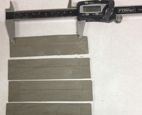 Measuring shrinkage samples from a slip-cast slab.