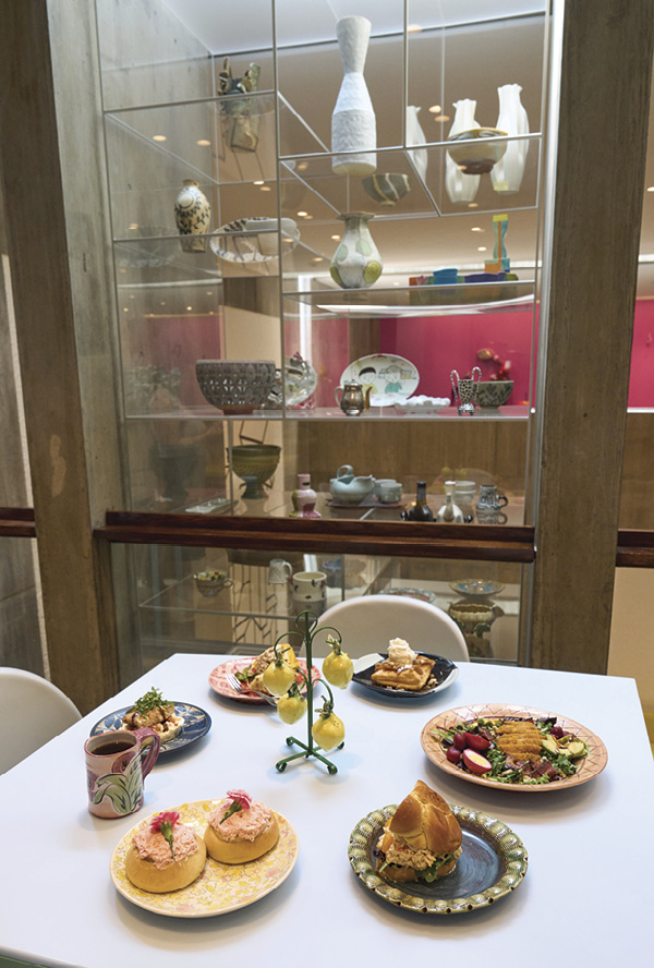 2 View of artistic collaboration between chef Danielle Mercuri Campolito’s creative nourishment and various ceramic works from the Rosenfield Collection. In the background, view the top of a 20-foot (6.1-m) tower that holds works from numerous artists.