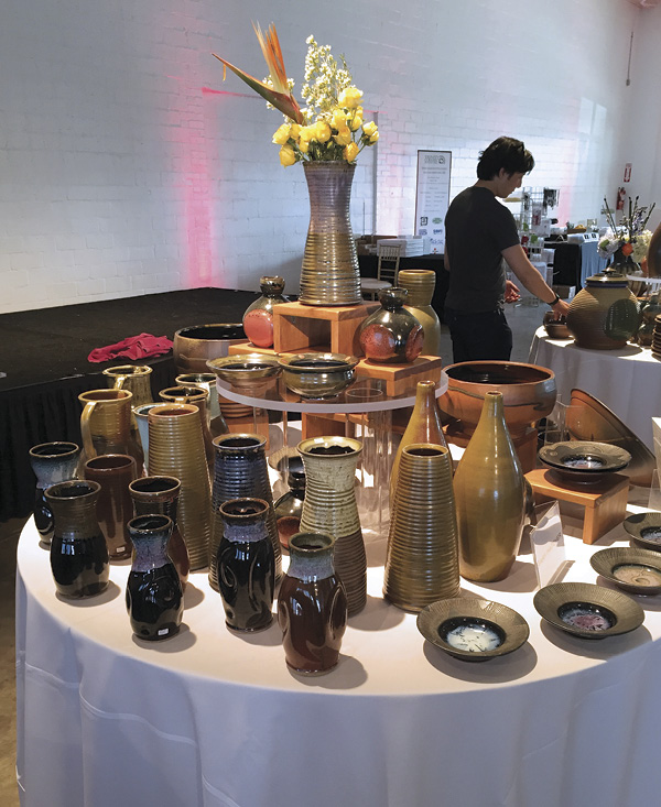 8 Dallas Pottery Invitational table display of Gary Hatcher with floral work by Sage Blooms, a flower design studio in Richardson, Texas. The designers provide floral arrangements in many vessels for the weekend-long show. Photo: Karla Barfield.