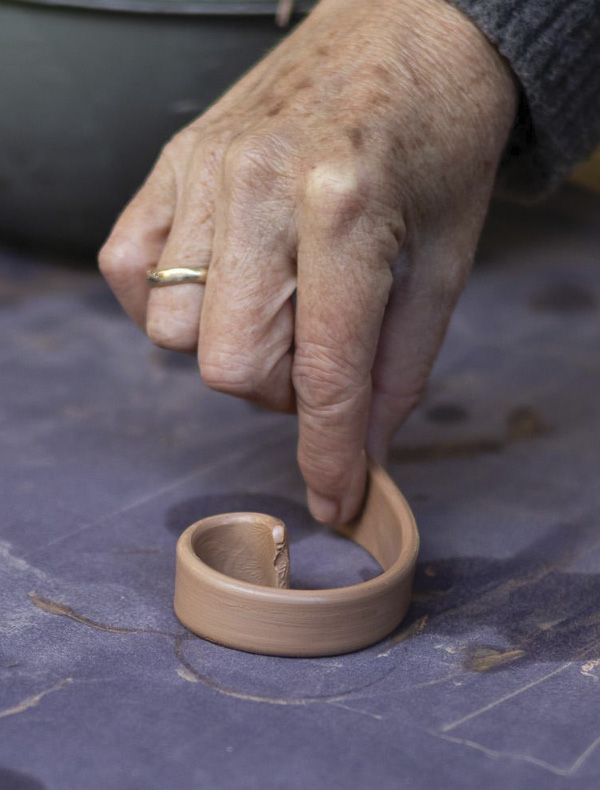 13 Set the handle on its edge and shape into a loose spiral to firm up.