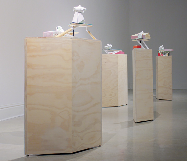 1 Wade MacDonald’s Utterly Forgettable Homes (installation view), dimensions variable, slip-cast and press-molded porcelain and stoneware, underglazes, glaze, fired in oxidation to cone 5, wood, Plexiglas, paper, acrylic paint, 2019.