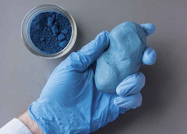 7 Wearing gloves and a dust mask, use ceramic pigment to make tinted clay for the background.