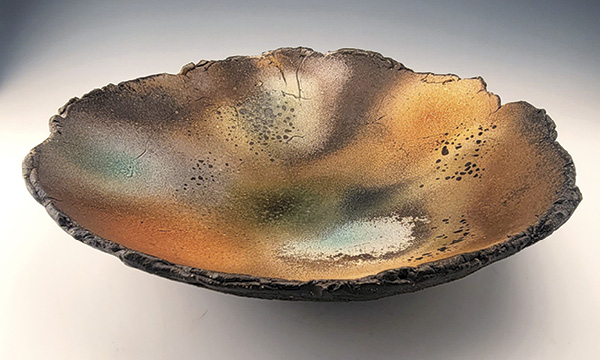 2 Lake Bed, Rustic Platter, 16 in. (40.6 cm) in diameter, mid-fired black clay, handbuilt, layered black clay slip and crushed calcite, sprayed with a combination of glazes and ash, fired multiple times in oxidation to cone 6, 2022.