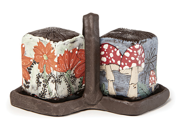 7 Teresa Pietsch’s salt-and-pepper set, 7 in. (17.8 cm) in height, handbuilt black earthenware, glazes, underglazes, image transfer, fired to cone 1 in a soda kiln.