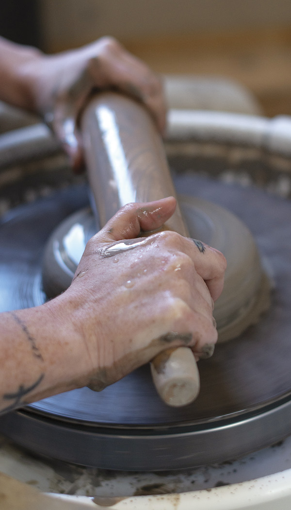 1 With your clay centered, firmly hold the rolling pin on both ends.