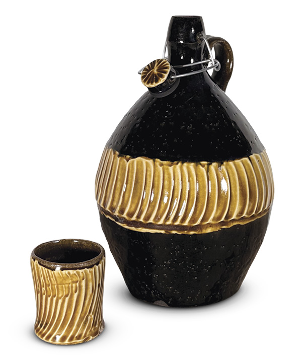 Kat Wheeler’s Swing Top Whiskey Bottle and Sipper, 10¼ in. (26 cm) in height, wheel-thrown ceramic, black and thick slips, amber ash glaze, fired to cone 6.