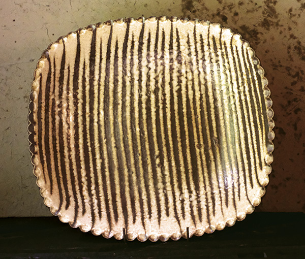 1 Yoji Yamada’s rectangular dish, 13 in. (34 cm) in diameter, stoneware, slip, 2025.