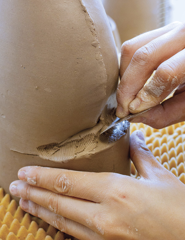 9 Blend the coil to the top and bottom seams of the opening with a serrated rib. Start to refine the angles.